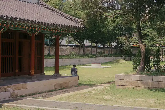 A man sitting on a Korean Temple